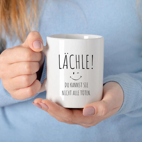 Lustige Tasse mit Spruch Lächle du kannst sie nicht alle töten